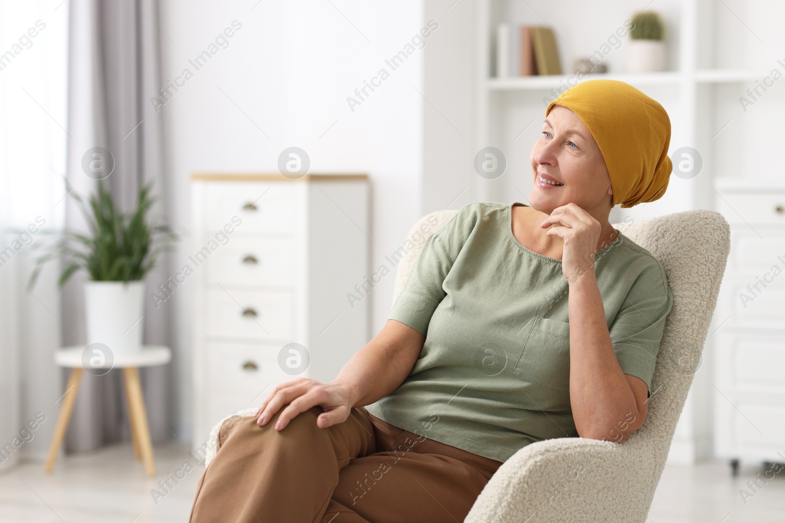 Photo of Senior woman with cancer on armchair at home