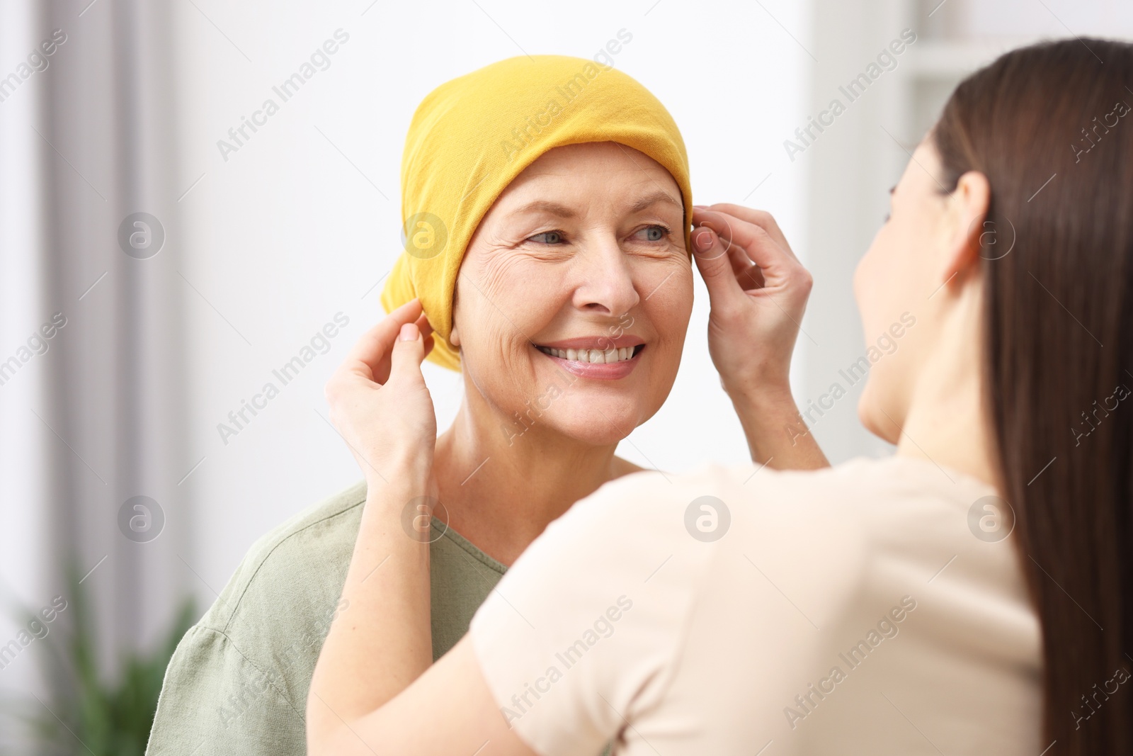 Photo of Caregiver helping woman with cancer at home