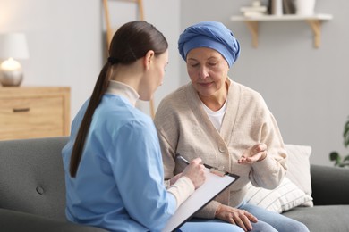 Woman with cancer and nurse at home