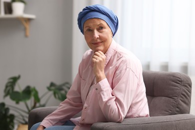 Senior woman with cancer on armchair at home