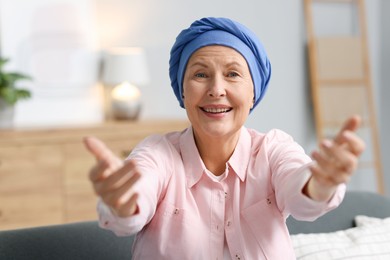 Photo of Senior woman with cancer greeting someone at home