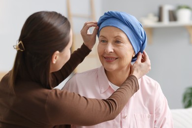 Photo of Caregiver helping woman with cancer at home