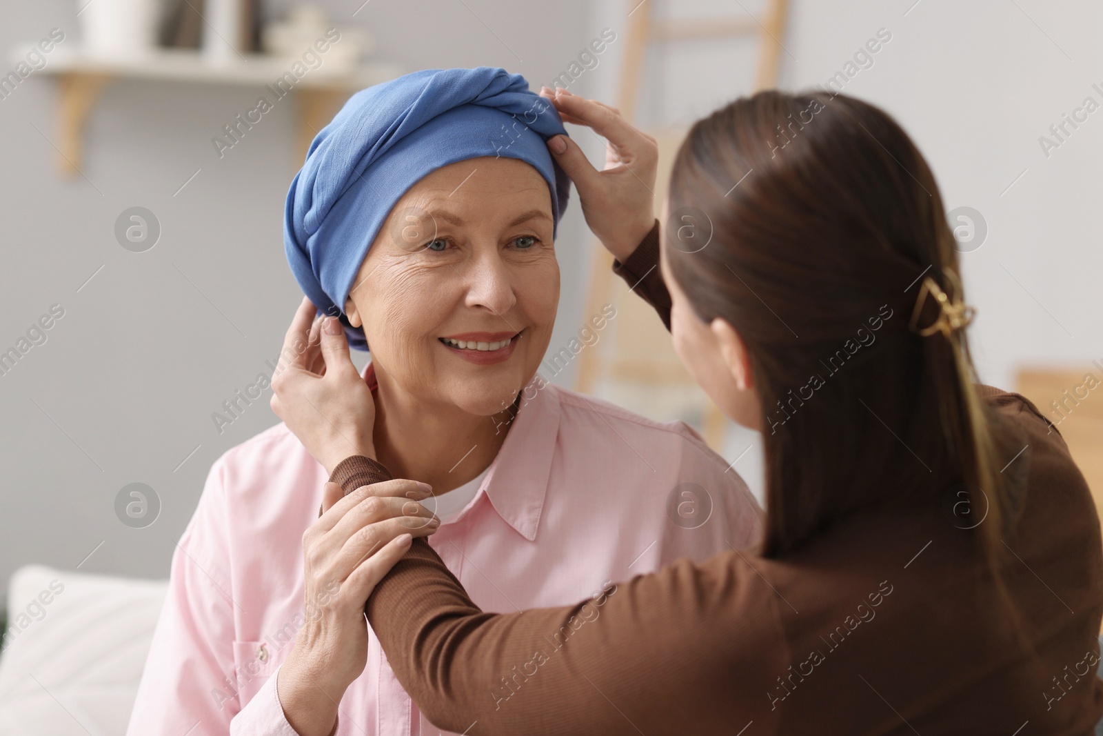 Photo of Caregiver helping woman with cancer at home