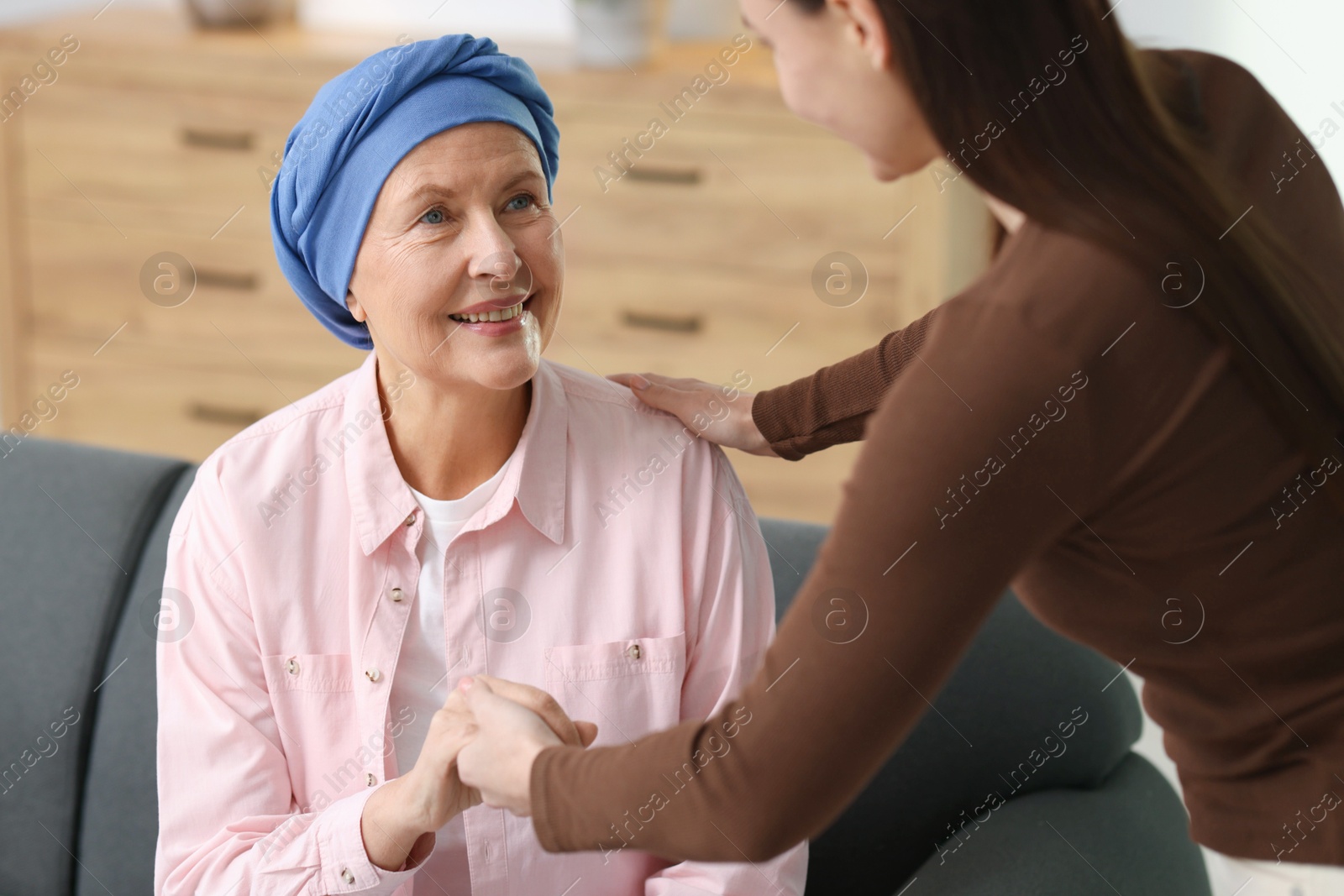 Photo of Caregiver helping woman with cancer at home