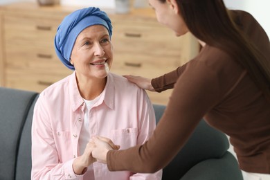 Photo of Caregiver helping woman with cancer at home