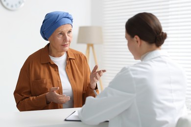 Photo of Senior woman with cancer visiting oncologist in clinic