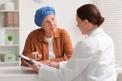 Photo of Senior woman with cancer visiting oncologist in clinic