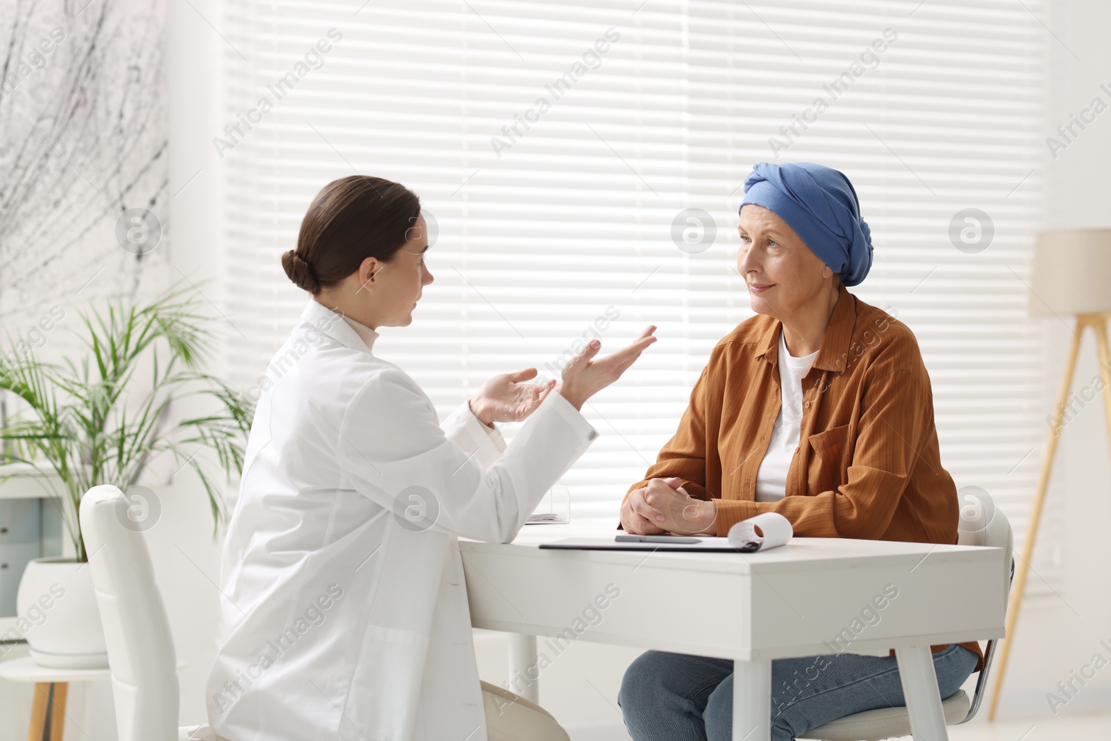 Photo of Senior woman with cancer visiting oncologist in clinic