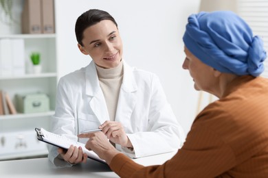 Photo of Senior woman with cancer visiting oncologist in clinic