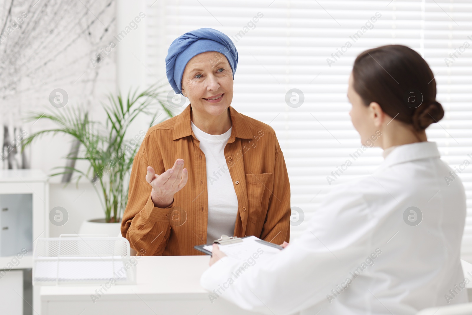 Photo of Senior woman with cancer visiting oncologist in clinic