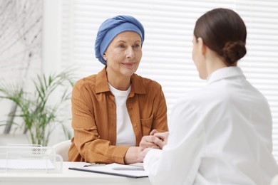 Photo of Senior woman with cancer visiting oncologist in clinic