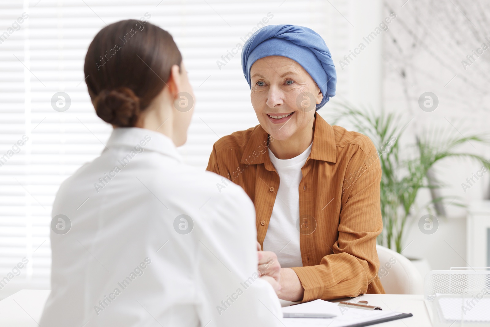 Photo of Senior woman with cancer visiting oncologist in clinic