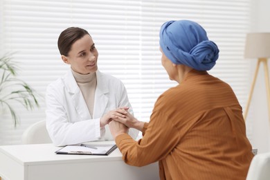 Photo of Senior woman with cancer visiting oncologist in clinic