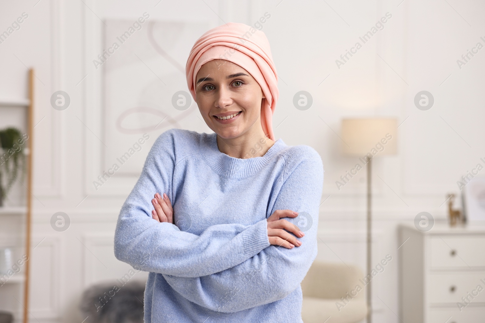 Photo of Portrait of smiling woman with cancer in headscarf indoors