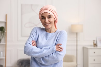 Photo of Portrait of smiling woman with cancer in headscarf indoors