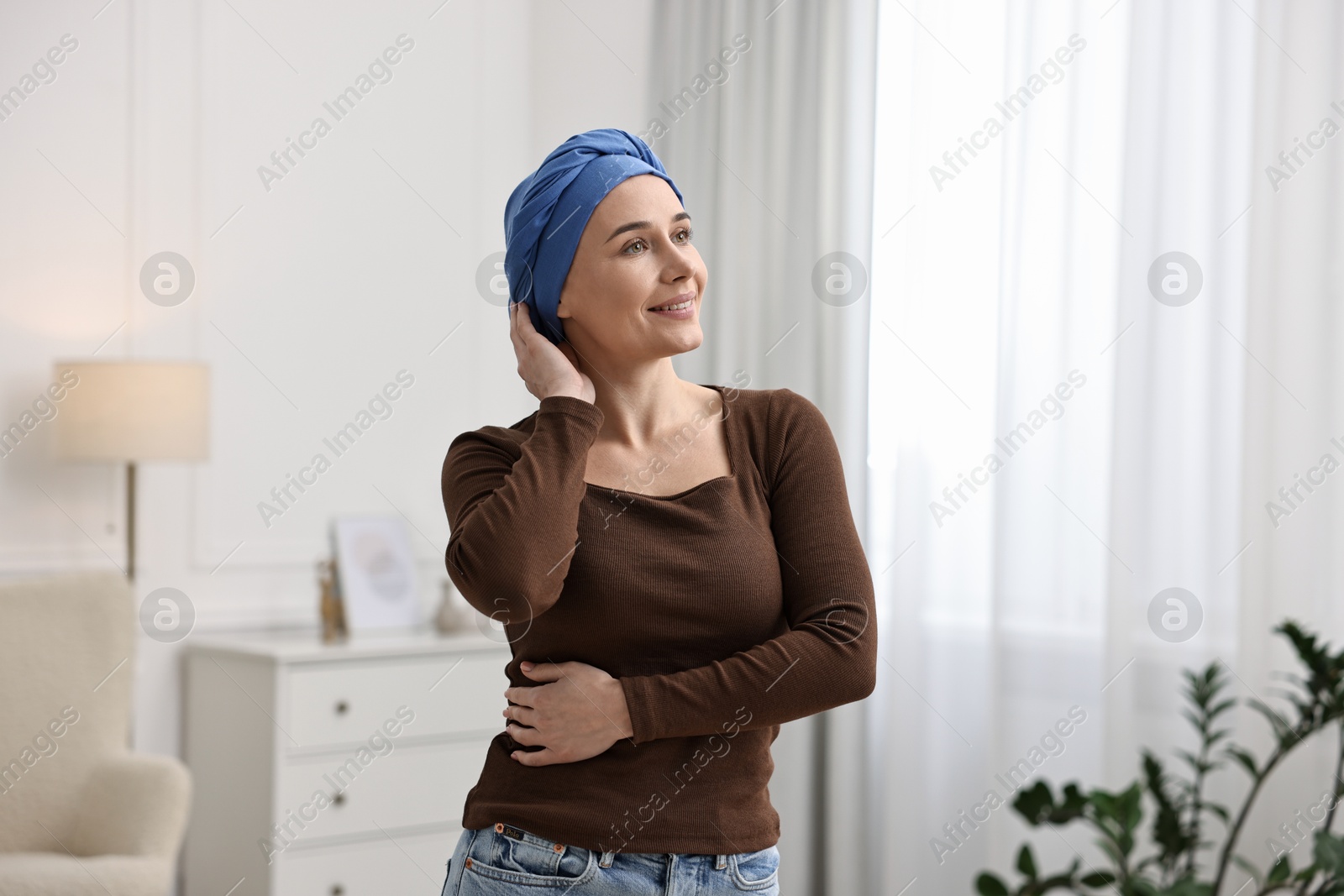 Photo of Smiling woman with cancer in headscarf indoors