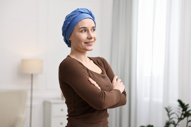 Photo of Smiling woman with cancer in headscarf indoors