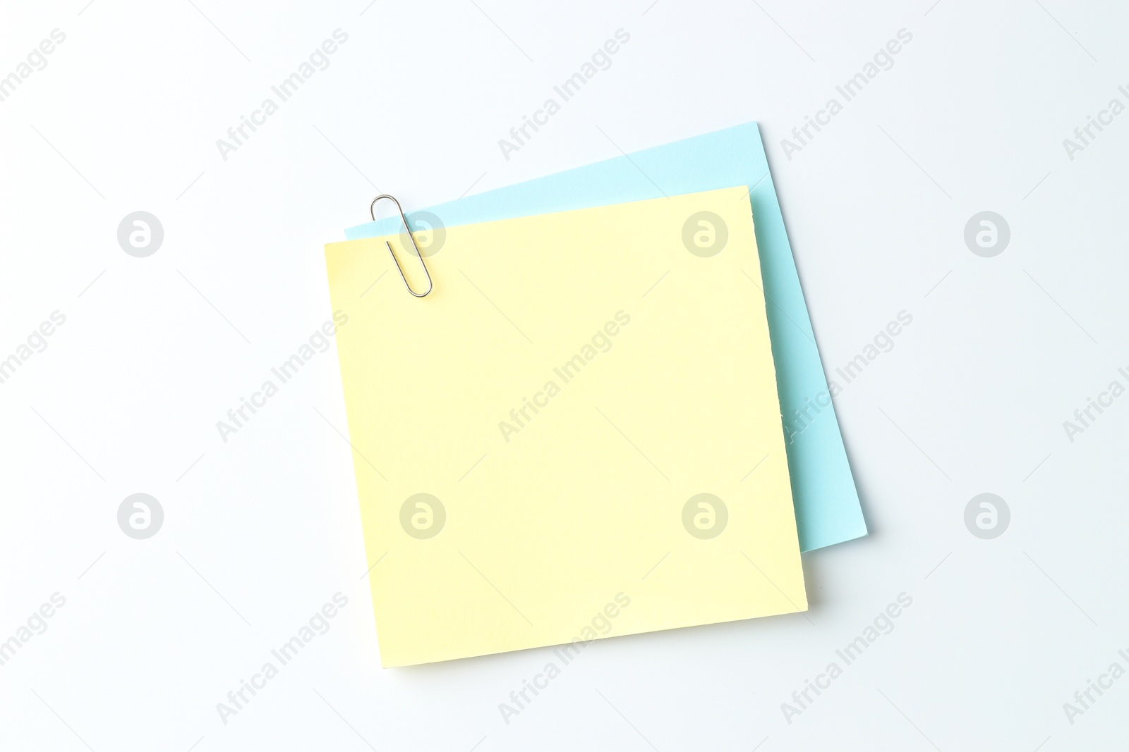 Photo of Paper notes with clip on light background, top view