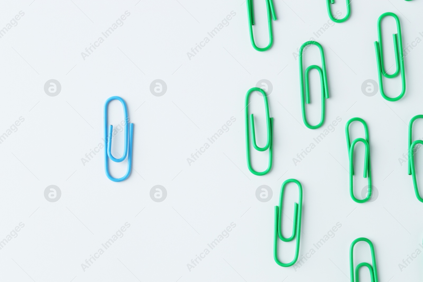 Photo of Many paper clips on light background, flat lay