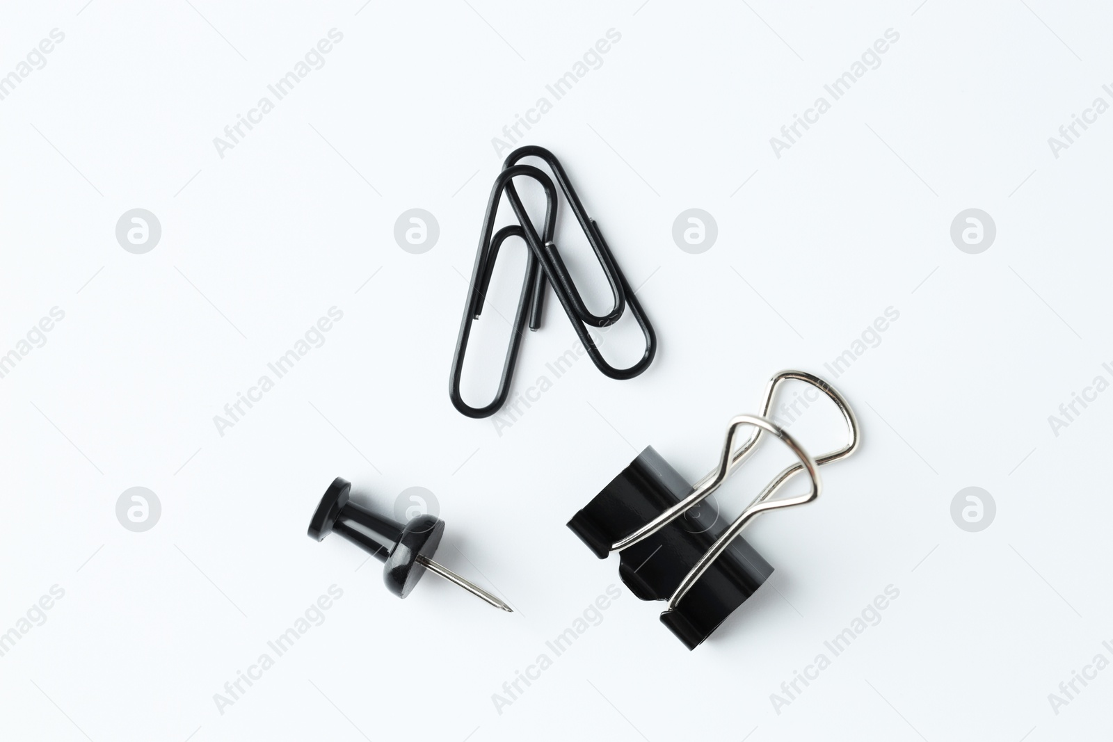 Photo of Paper clips and pin on white background, flat lay