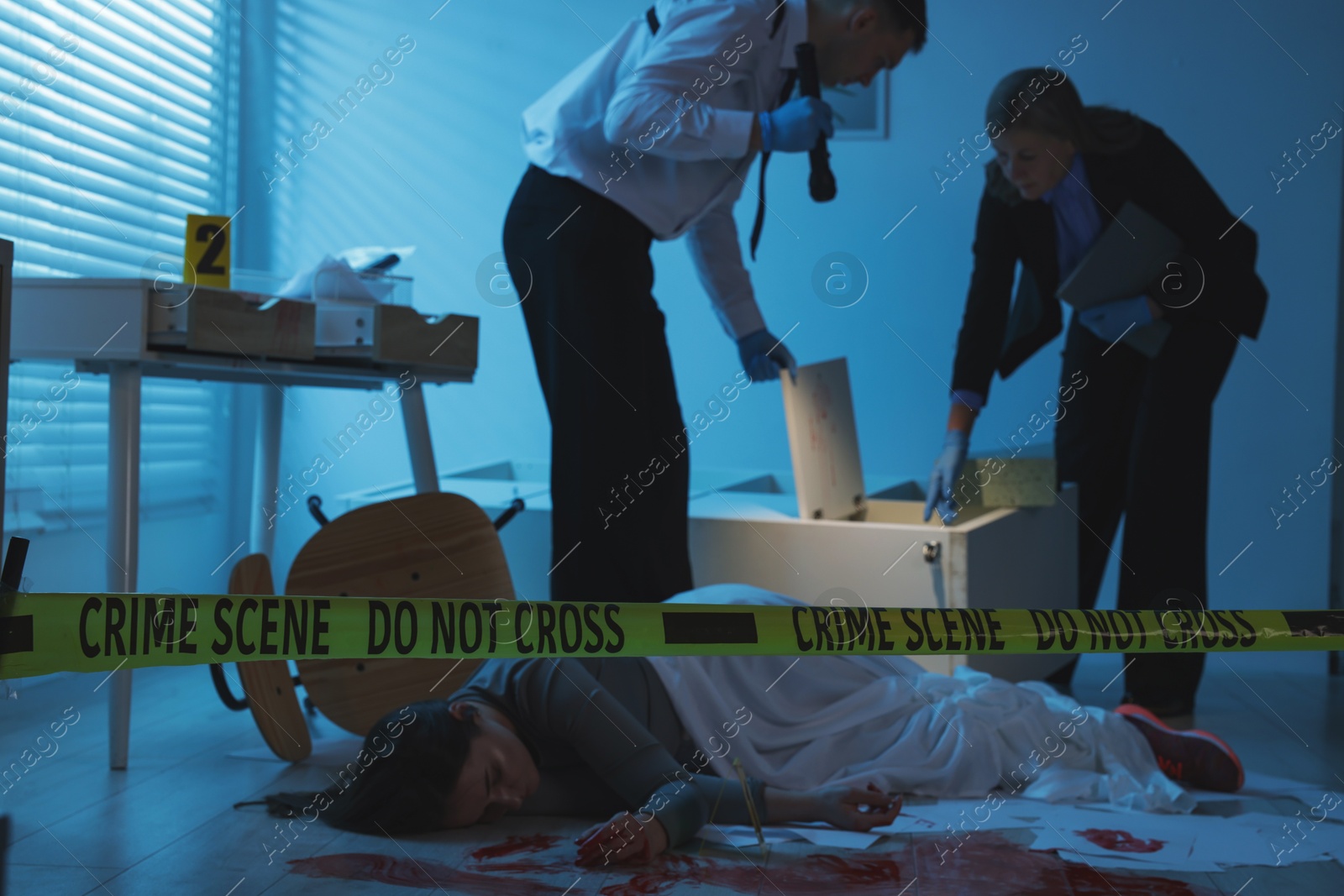 Photo of Forensic experts working at crime scene with dead woman's body indoors, selective focus