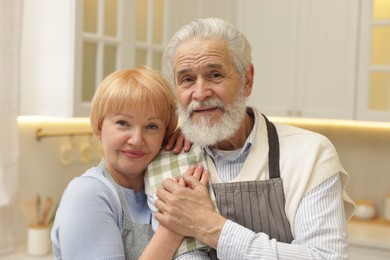 Photo of Portrait of happy senior couple in kitchen