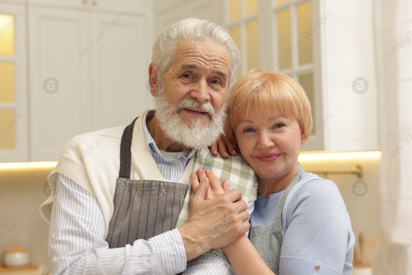 Photo of Portrait of happy senior couple in kitchen