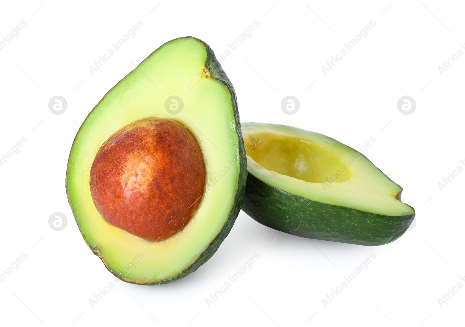 Photo of Halves of ripe avocado isolated on white