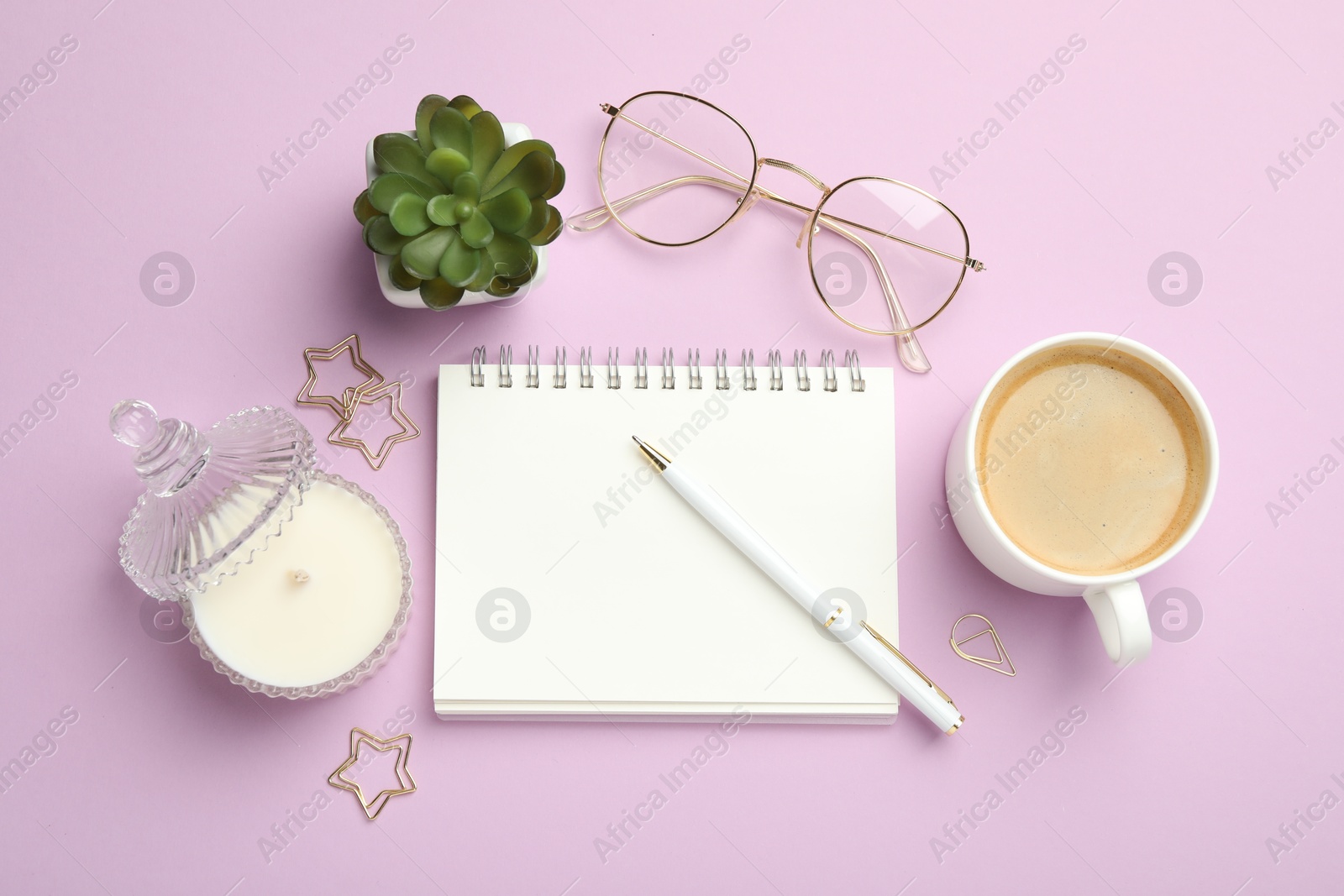 Photo of Paper clips, other different stationery, glasses, coffee and decor on lilac background, flat lay