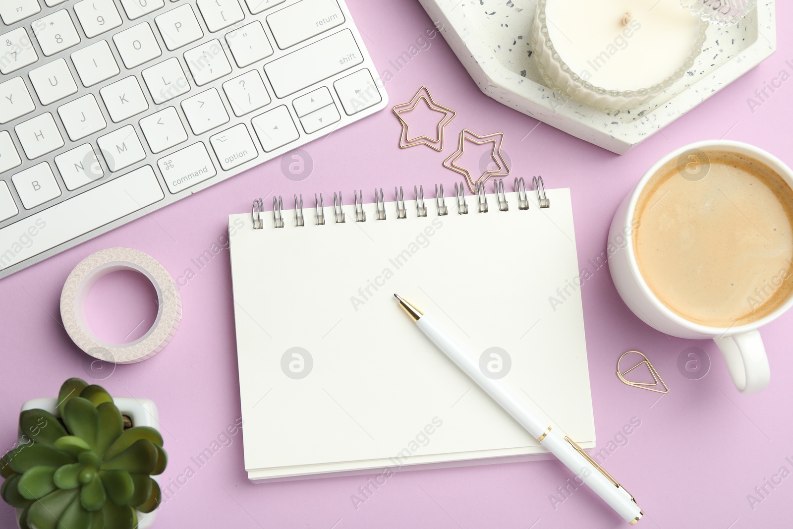 Photo of Paper clips, other different stationery, computer keyboard, coffee and decor on lilac background, flat lay