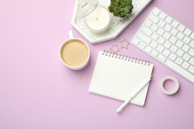 Photo of Paper clips, other different stationery, computer keyboard, coffee and decor on lilac background, flat lay. Space for text