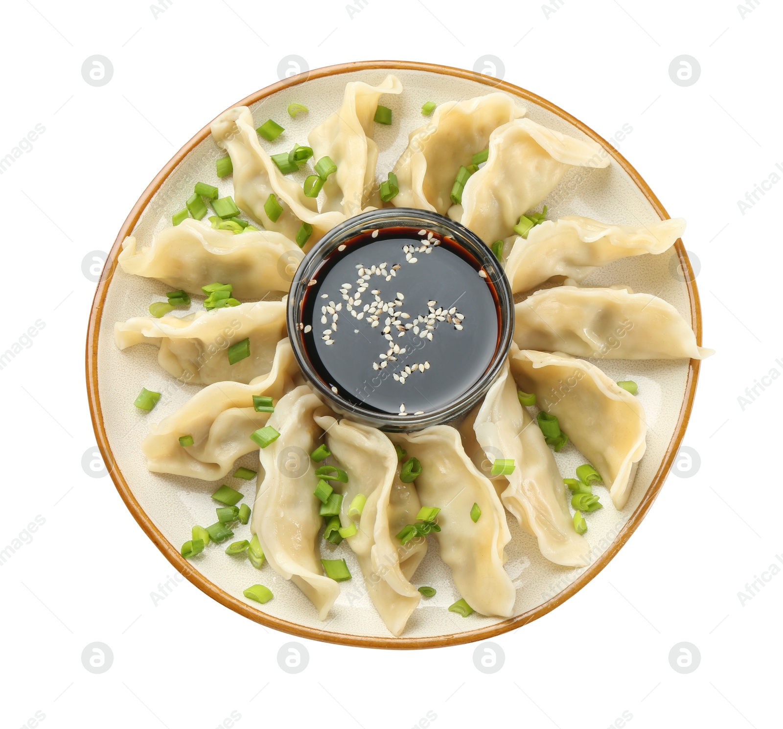 Photo of Tasty boiled gyoza (dumplings) with green onion and soy sauce on white background, top view