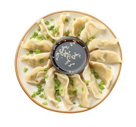 Photo of Tasty boiled gyoza (dumplings) with green onion and soy sauce on white background, top view