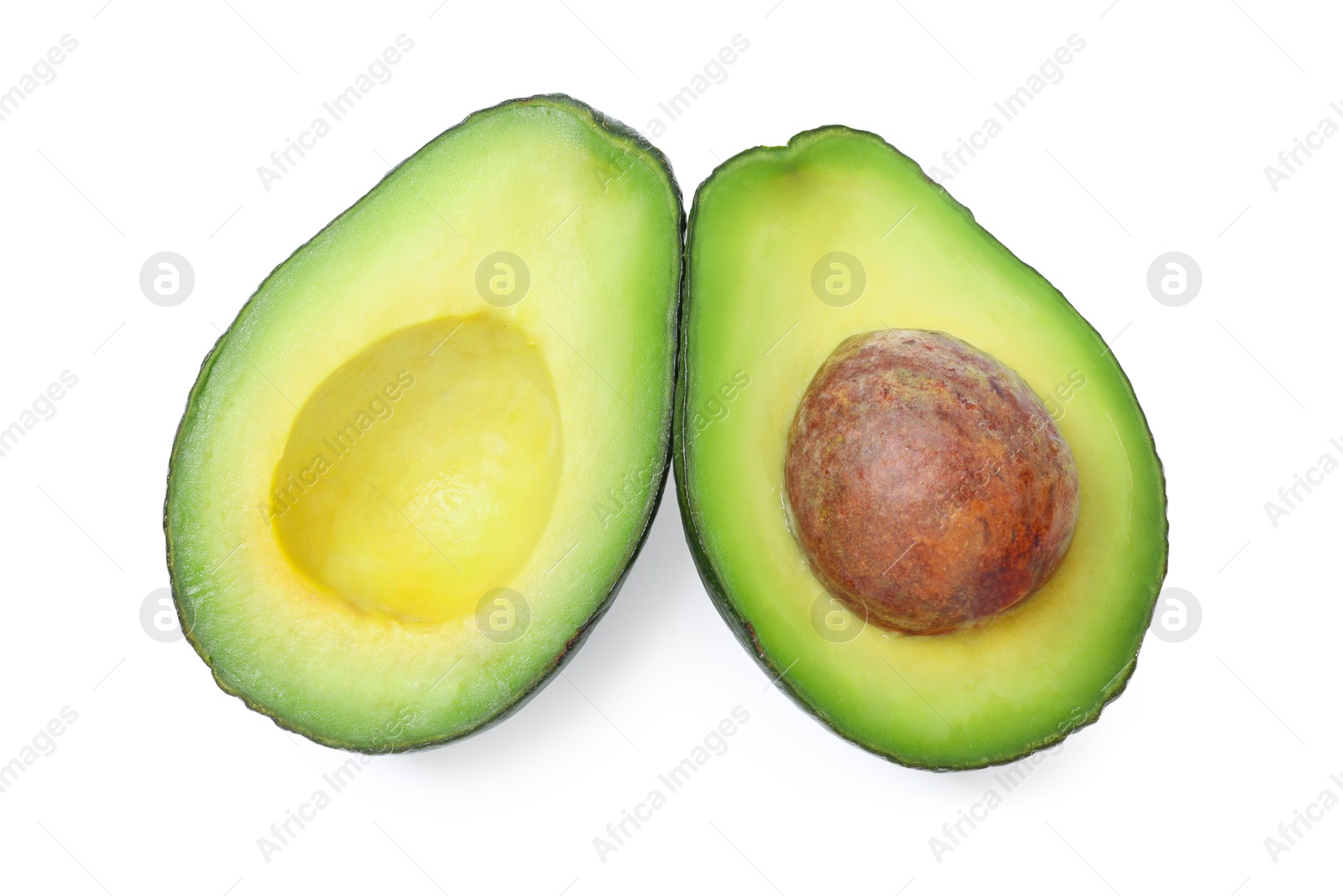 Photo of Halves of ripe avocado isolated on white, top view