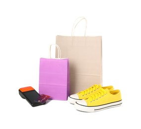 Photo of Payment terminal, shopping bags, credit card and sneakers isolated on white