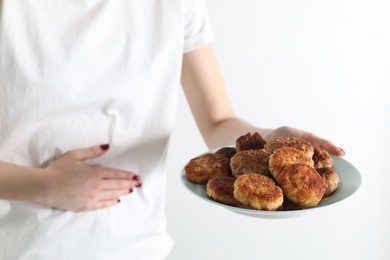 Photo of Woman with patties suffering from abdominal pain on white background, closeup. Food allergy concept