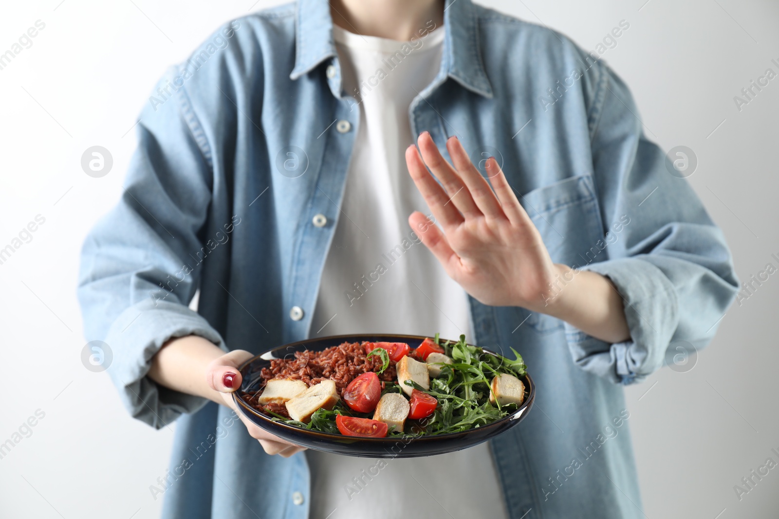 Photo of Woman refusing to eat meal on white background, closeup. Food allergy concept