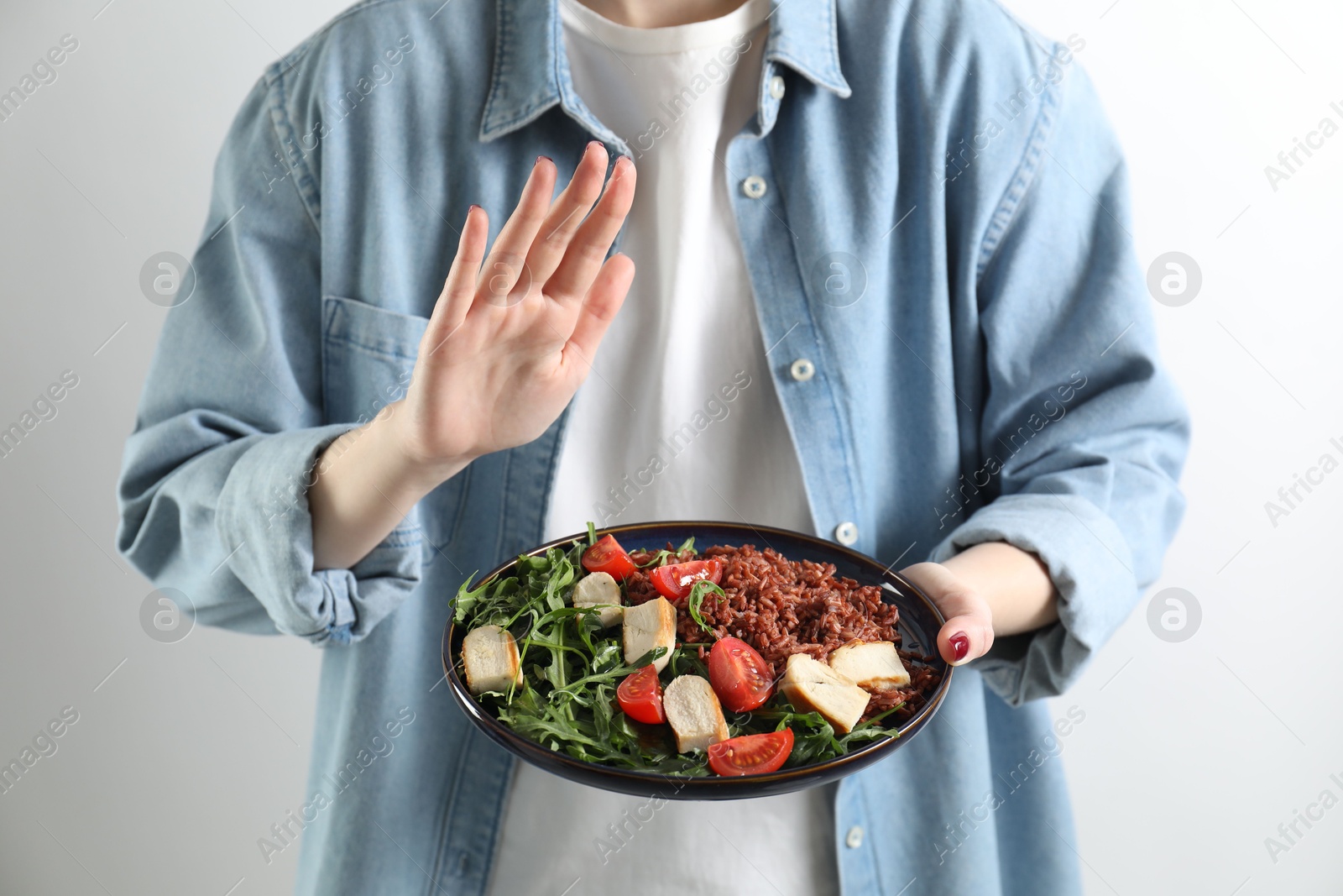 Photo of Woman refusing to eat meal on white background, closeup. Food allergy concept