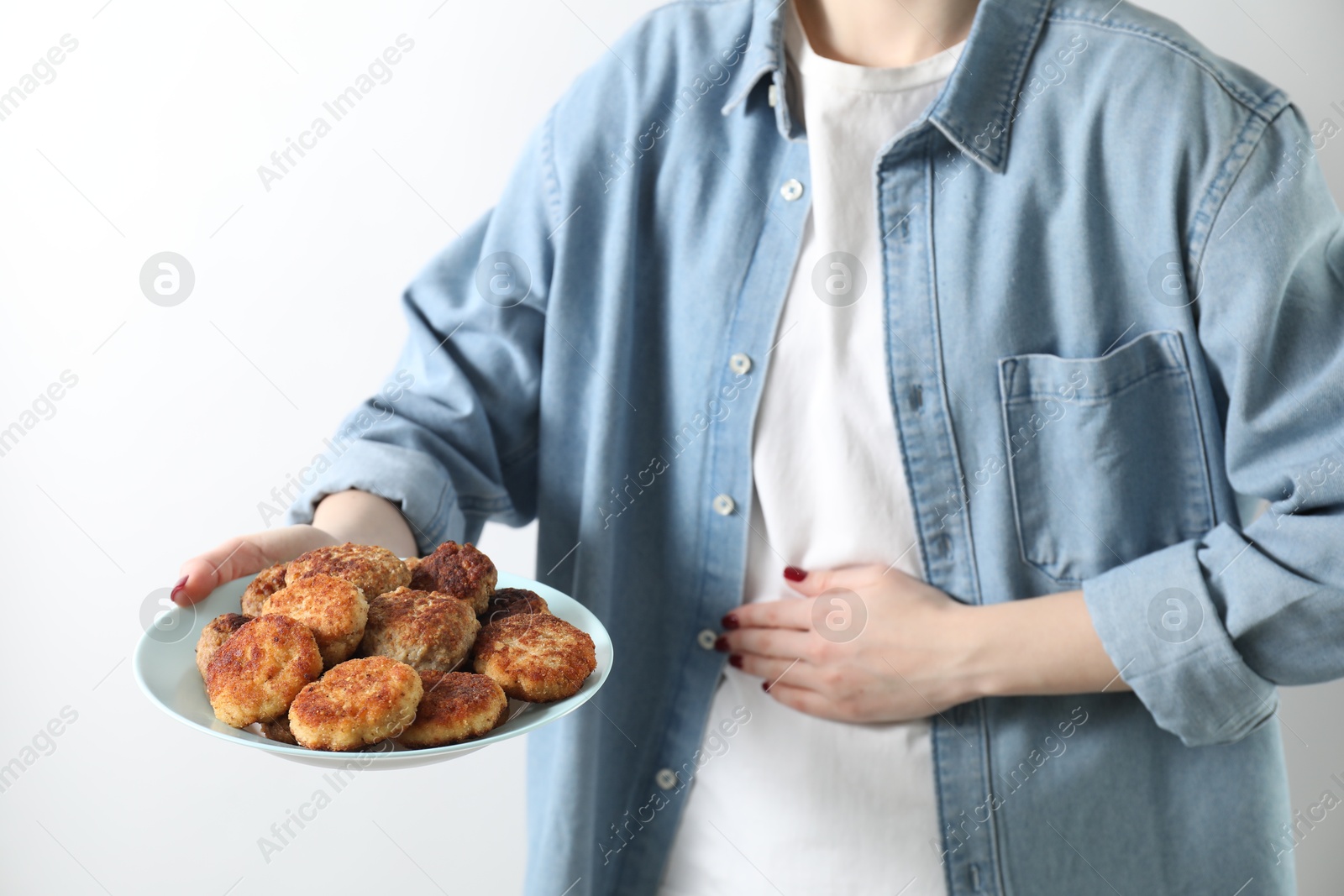 Photo of Woman with patties suffering from abdominal pain on white background, closeup. Food allergy concept