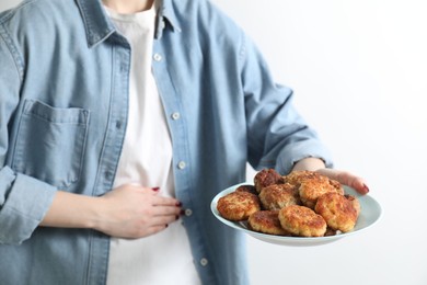 Photo of Woman with patties suffering from abdominal pain on white background, closeup. Food allergy concept