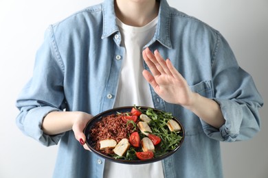 Photo of Woman refusing to eat meal on white background, closeup. Food allergy concept