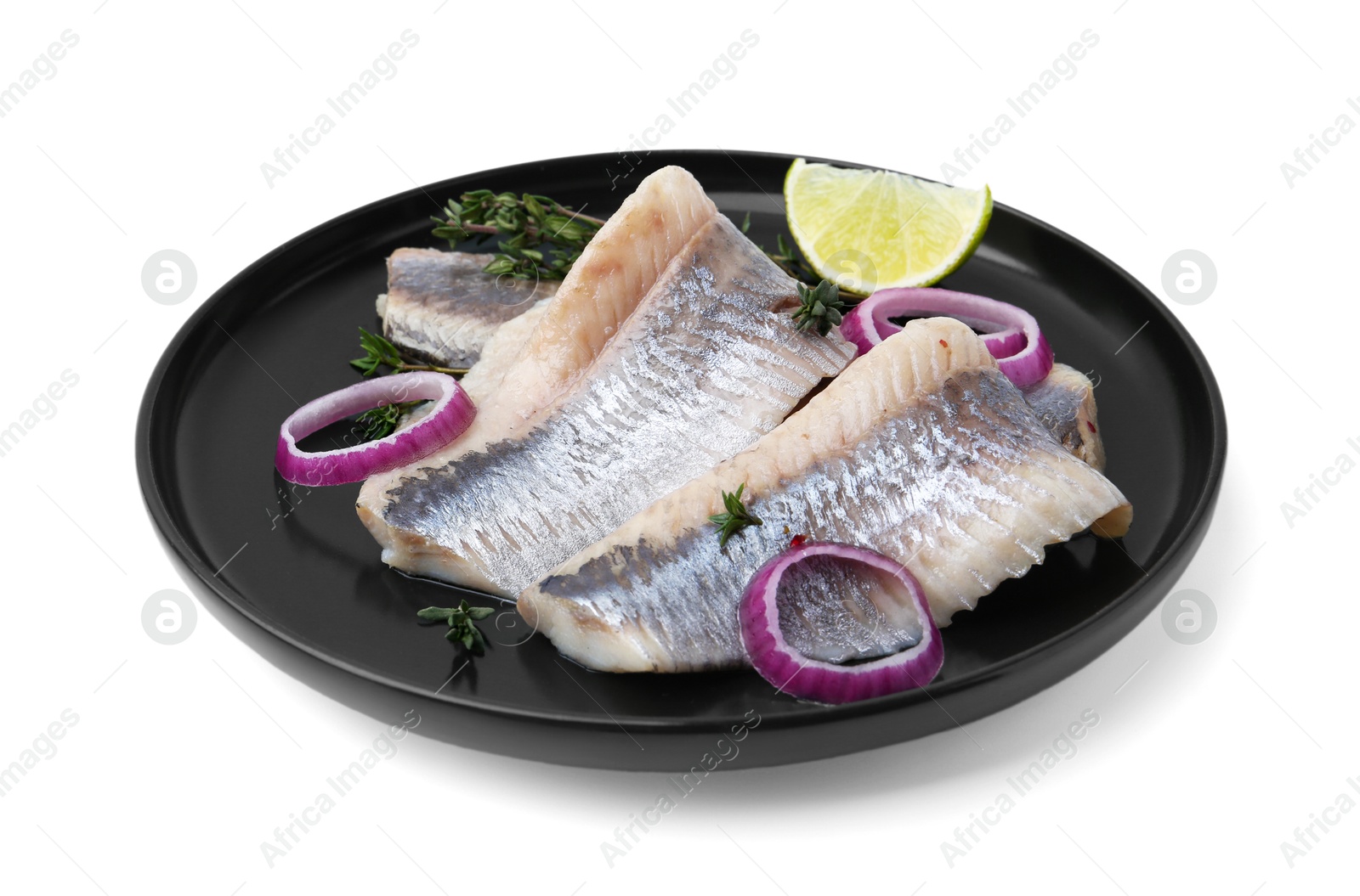 Photo of Marinated herring fillets with onion rings, thyme and lime isolated on white