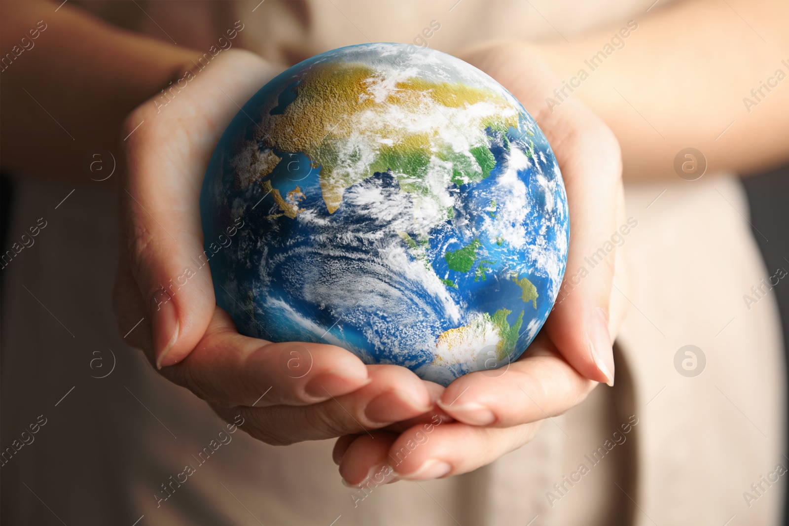 Image of Planet in our hands. Woman holding Earth model, closeup