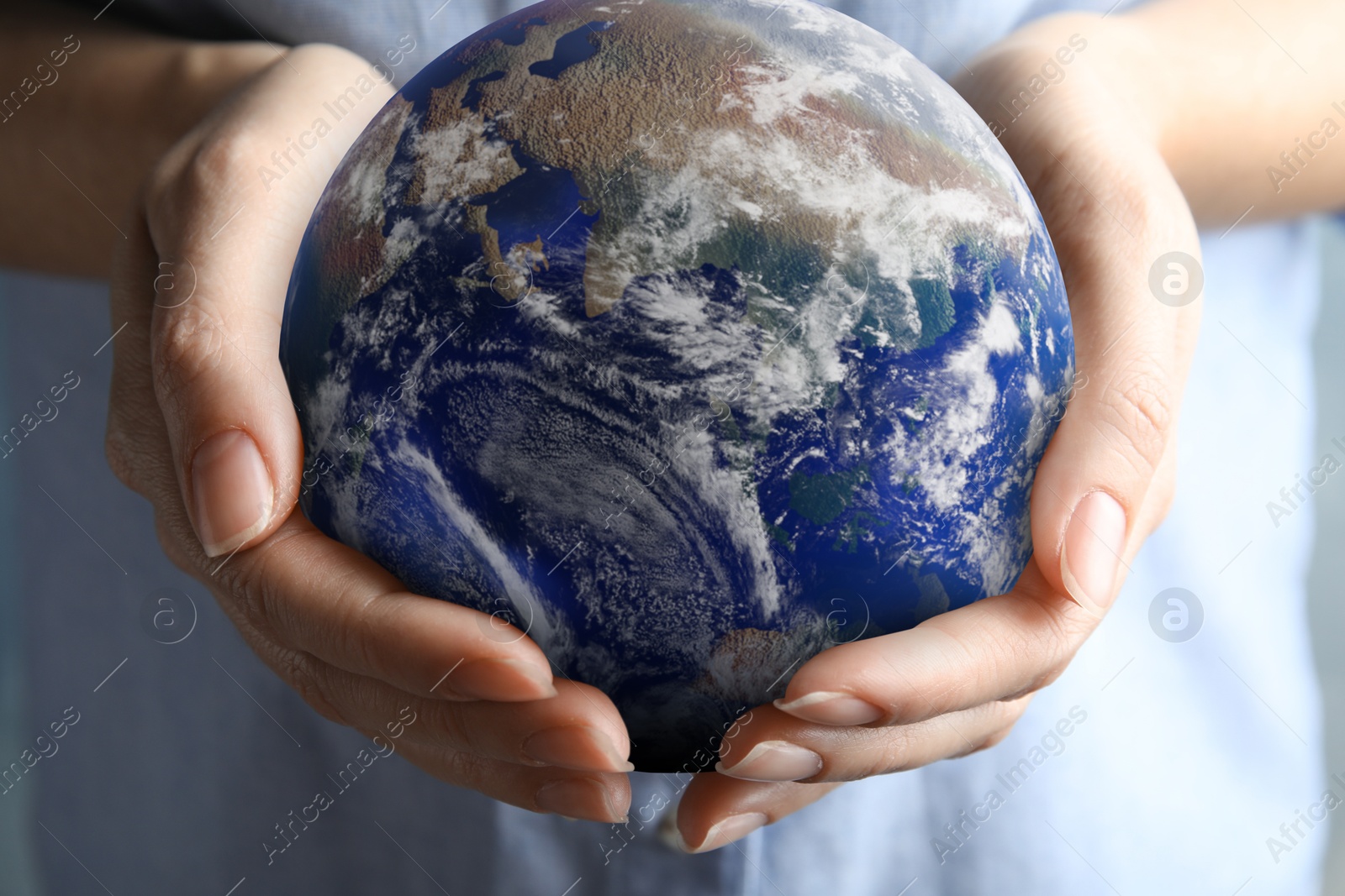 Image of Planet in our hands. Woman holding Earth model, closeup