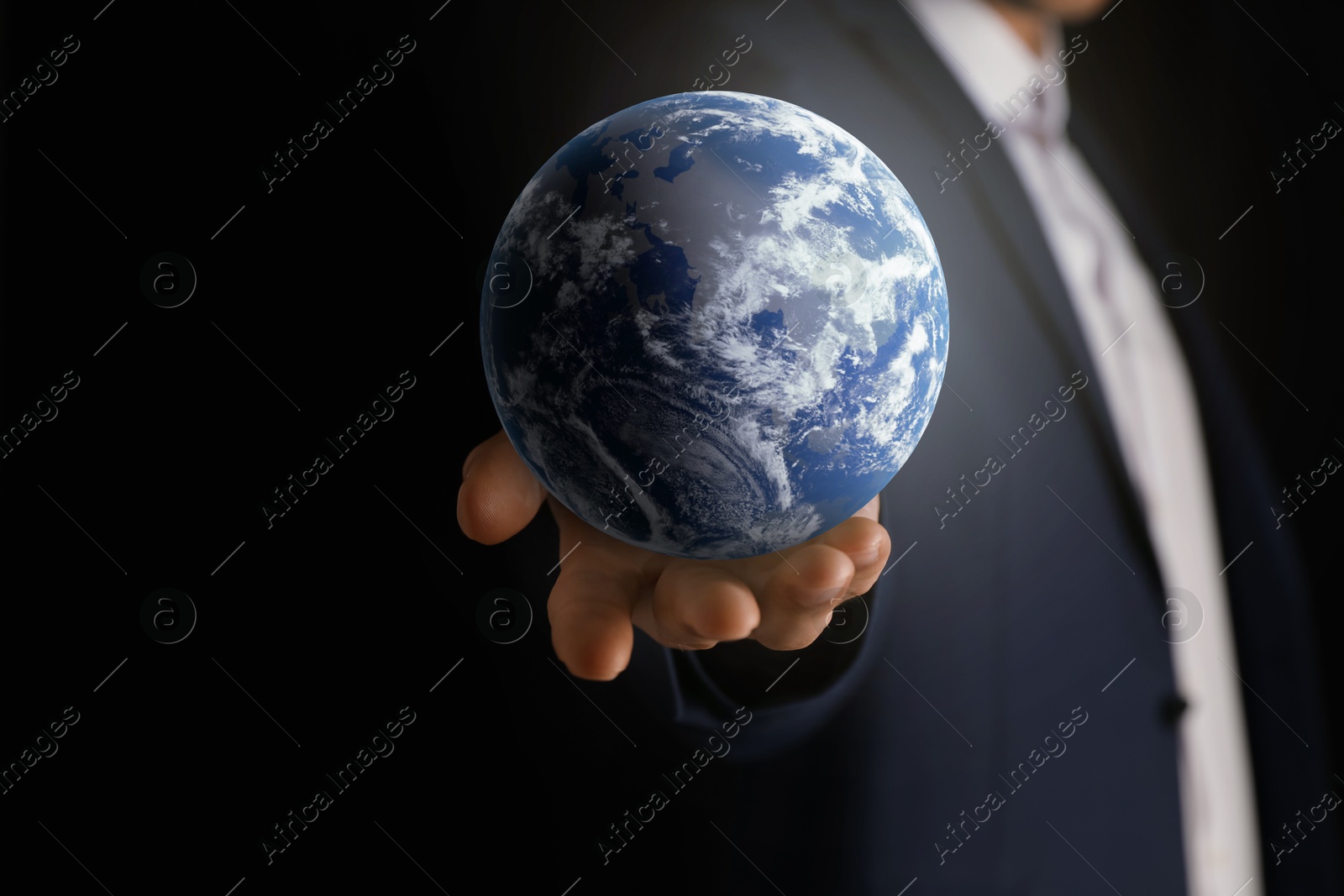 Image of Planet in our hands. Man holding Earth model on black background, closeup