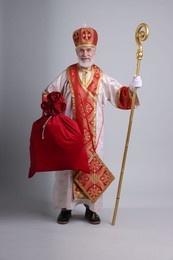 Photo of Saint Nicholas with sack on light grey background