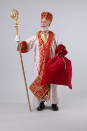 Photo of Saint Nicholas with sack on light grey background