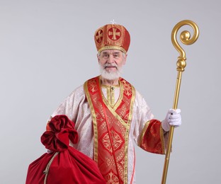 Photo of Saint Nicholas with sack on light grey background