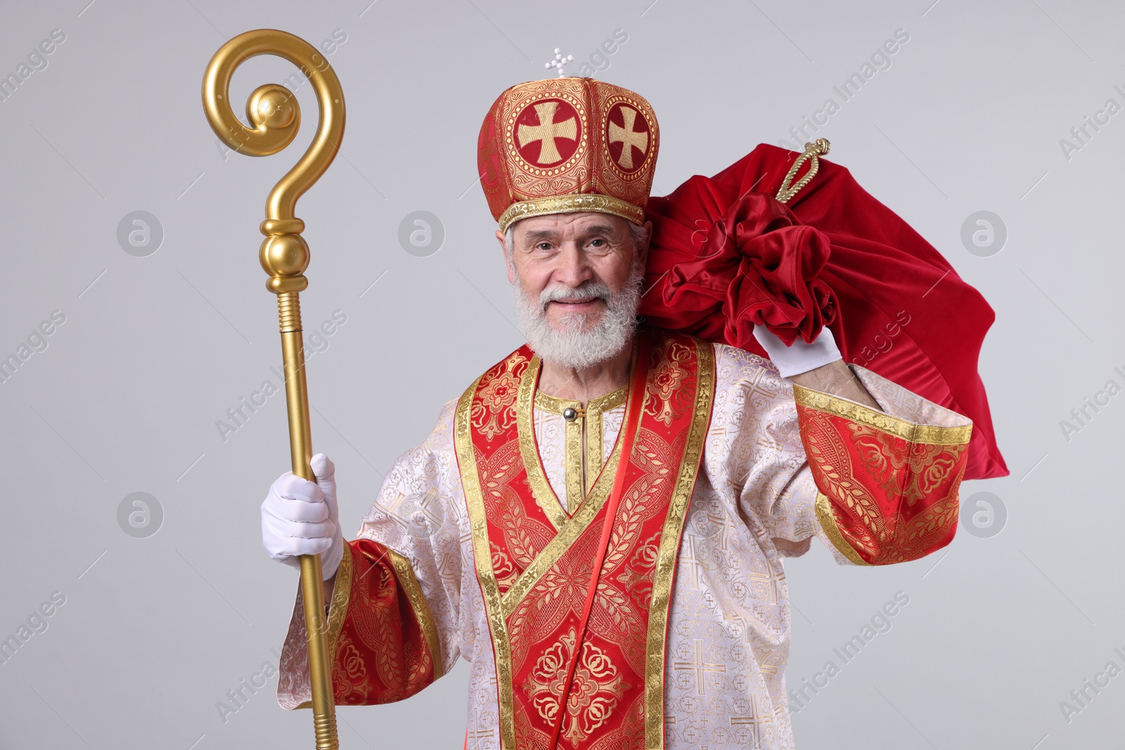 Photo of Saint Nicholas with sack on light grey background