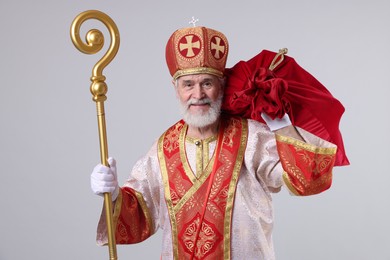 Photo of Saint Nicholas with sack on light grey background